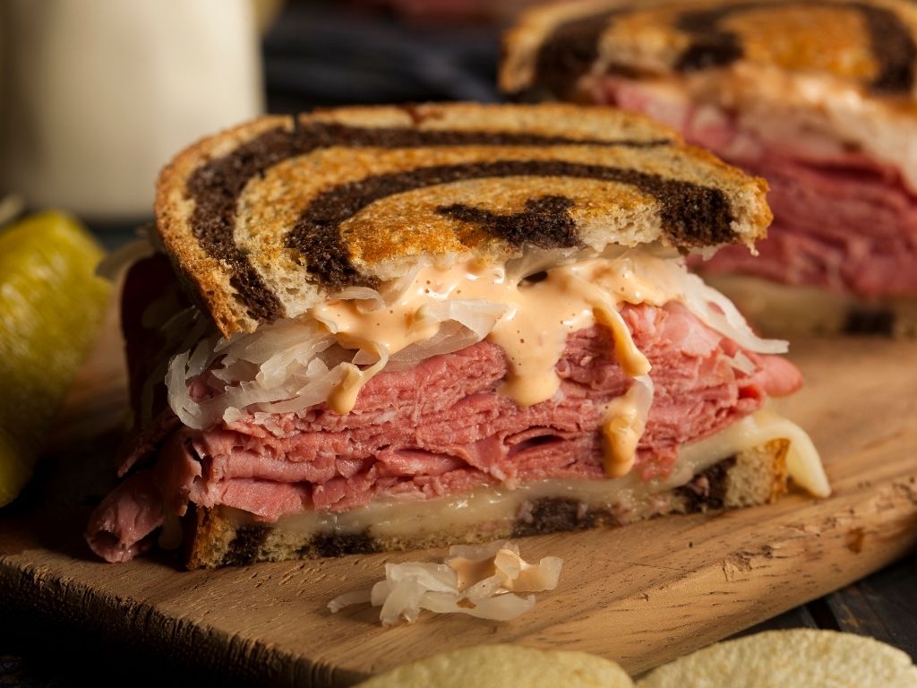 A mouth-watering image of a Reuben sandwich cross-section