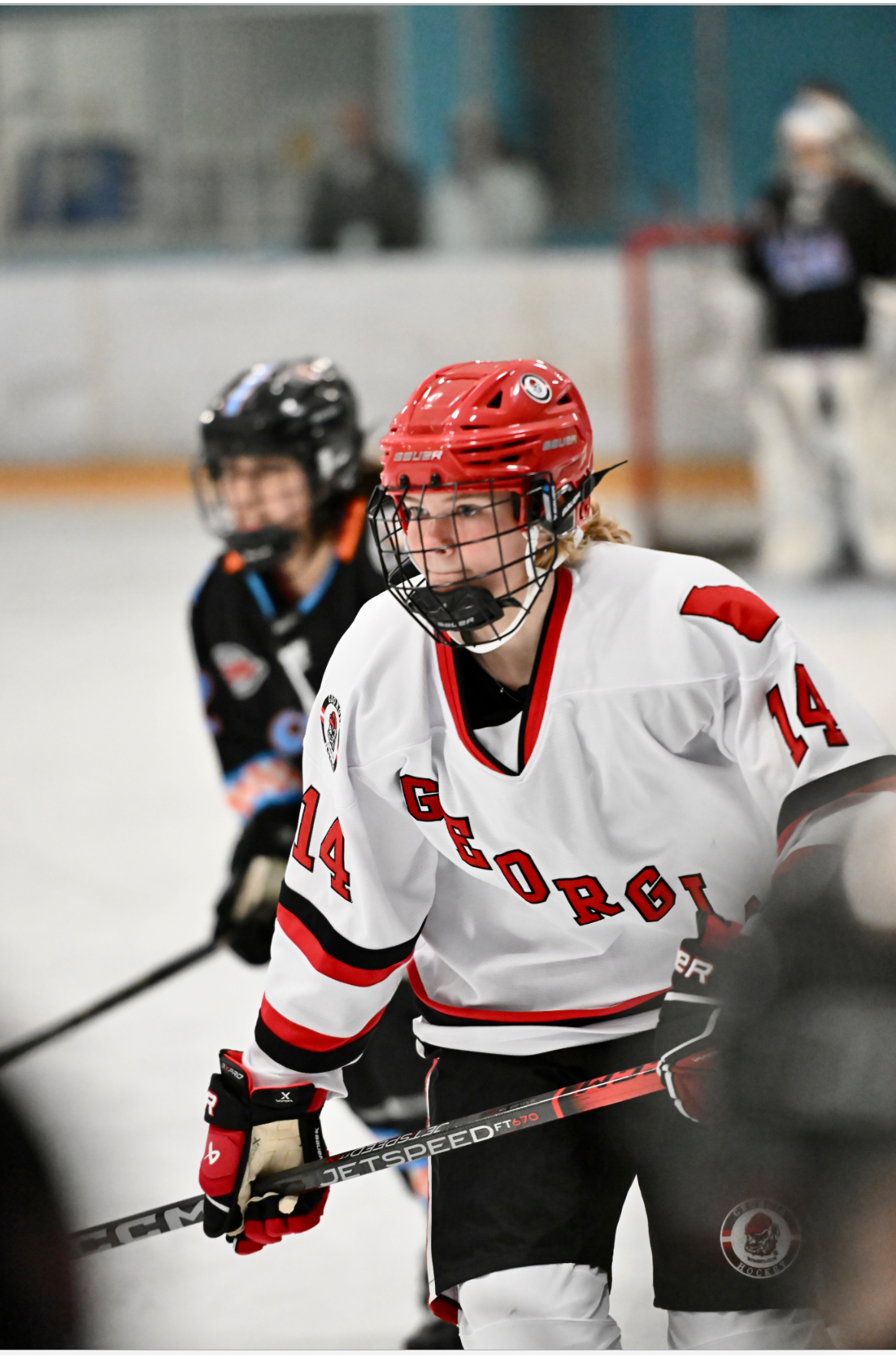An image of Eva set up at a faceoff in a hockey game. She has her game face on.